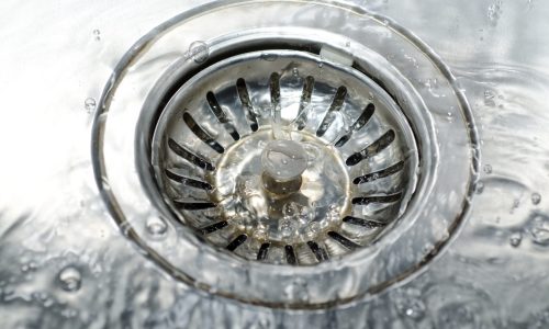 A high angle closeup shot of water pouring on the water drain